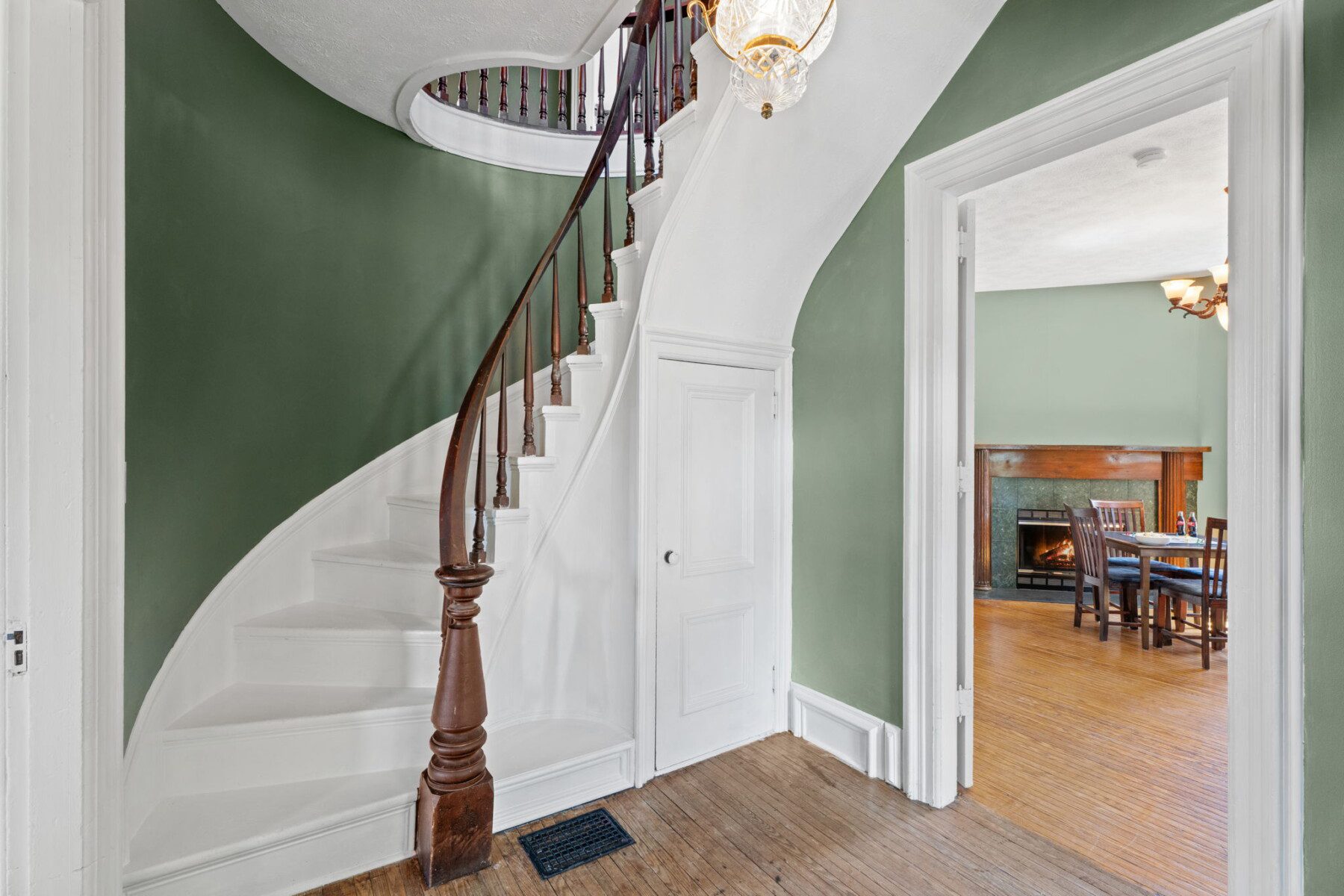 Historic charm welcomes you with a stunning curved staircase and timeless architectural details.
