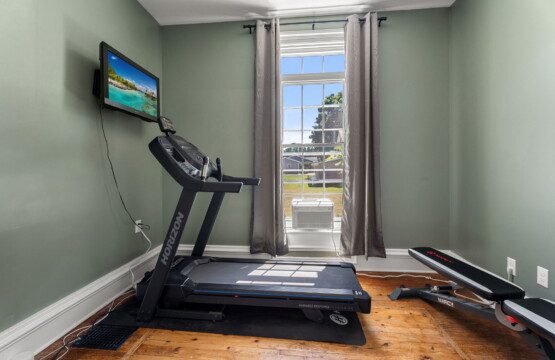 Keep up with your routine in the private fitness room, complete with a treadmill, weight bench, and TV.